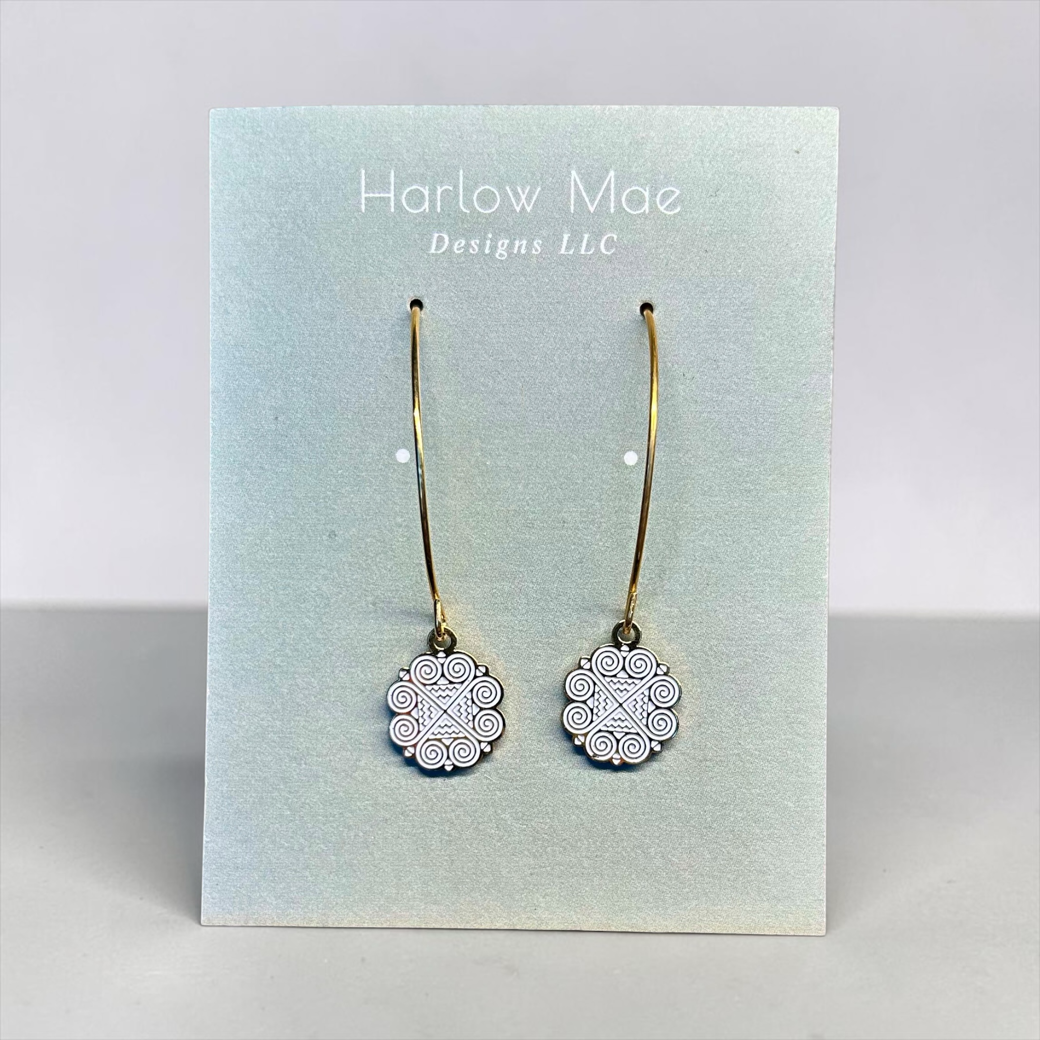 Harlow Mae Designs LLC delicate gold-tone hoop earrings with black and white patterned circular charms.