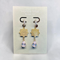Harlow Mae Designs LLC gold-tone drop earrings with star floral motif and pear-shaped cubic zirconia gemstone.