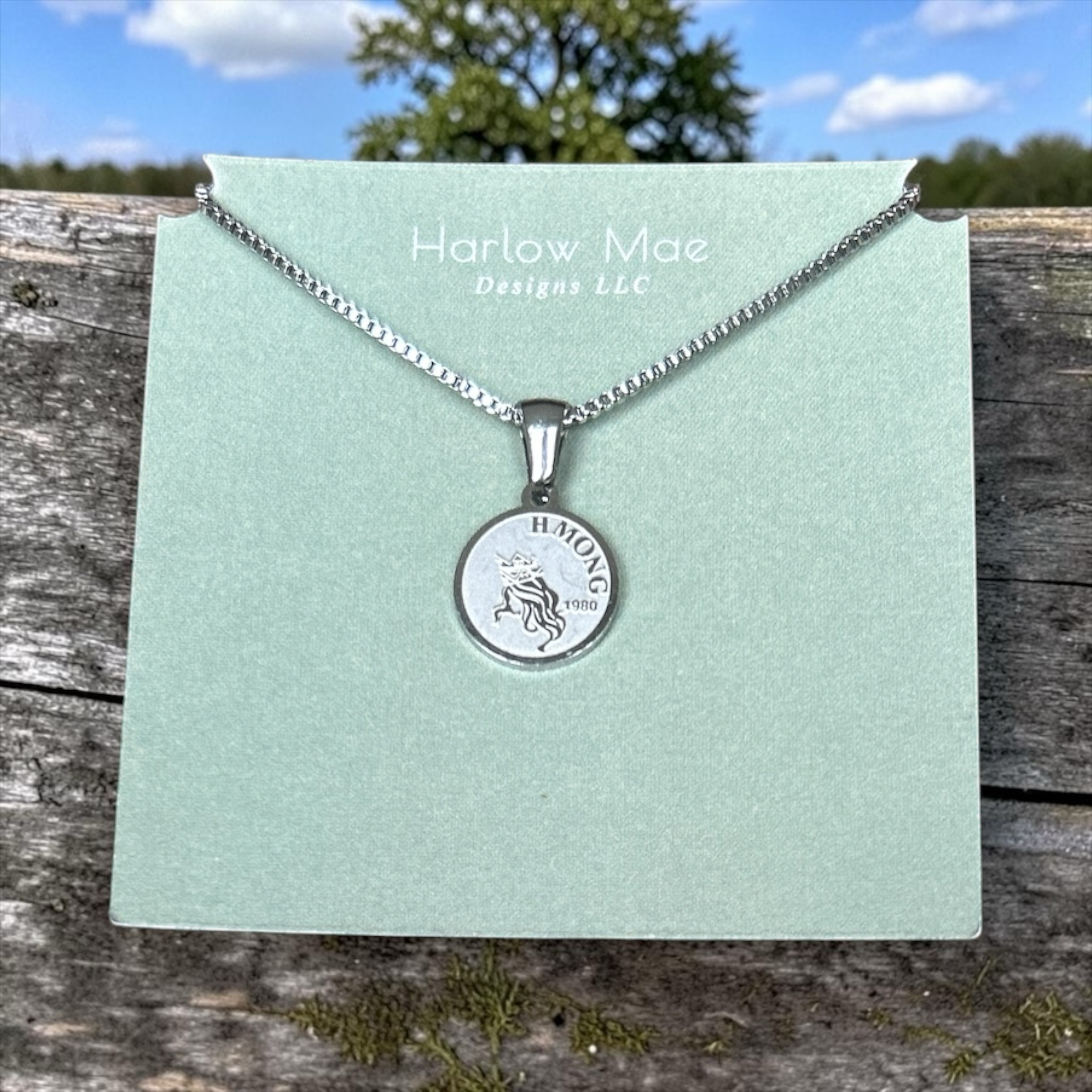 Harlow Mae Designs LLC silver-tone stainless steel necklace with unicorn pendant inscribed HMONG 1980.