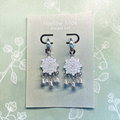 Harlow Mae Designs LLC ornate silver-tone dangle earrings with starburst motif and teardrop bells