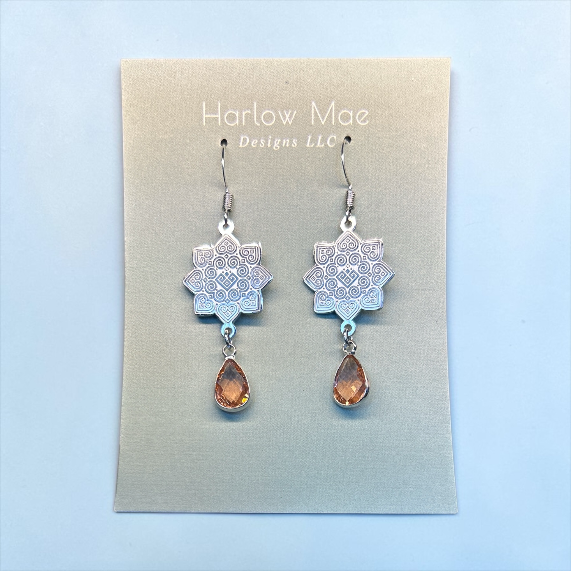 Harlow Mae Designs LLC ornate silver-toned mandala drop earrings with amber teardrop gemstone accent.