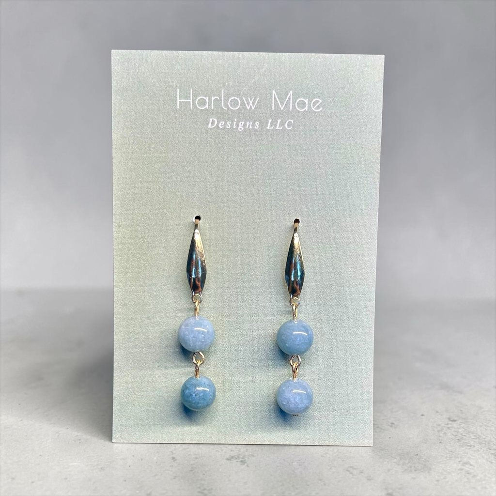 Harlow Mae double stone drop earrings with sky-blue beads and gold-tone metal accents.