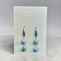 Harlow Mae double stone drop earrings with sky-blue beads and gold-tone metal accents.